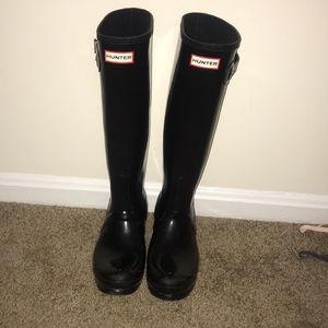Tall glossy black Hunter rain boots